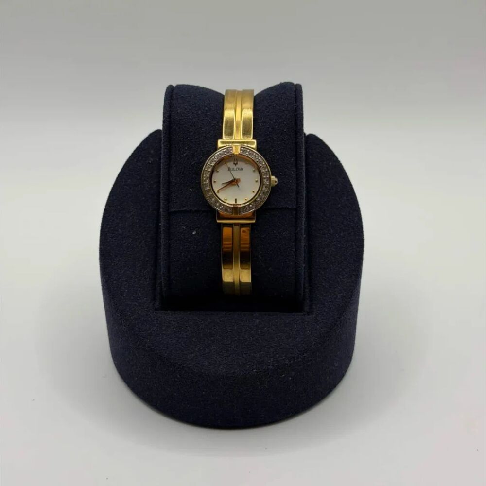 Bulova Gold Tone Half Bangle Diamond Bezel Mother Of Pearl Dial Ladies Watch